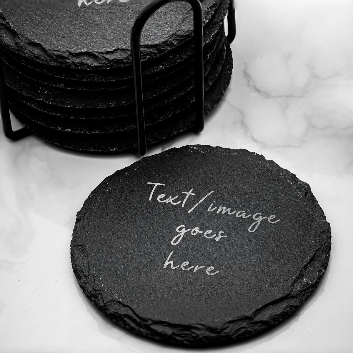 Personalized round slate coasters arranged on a table